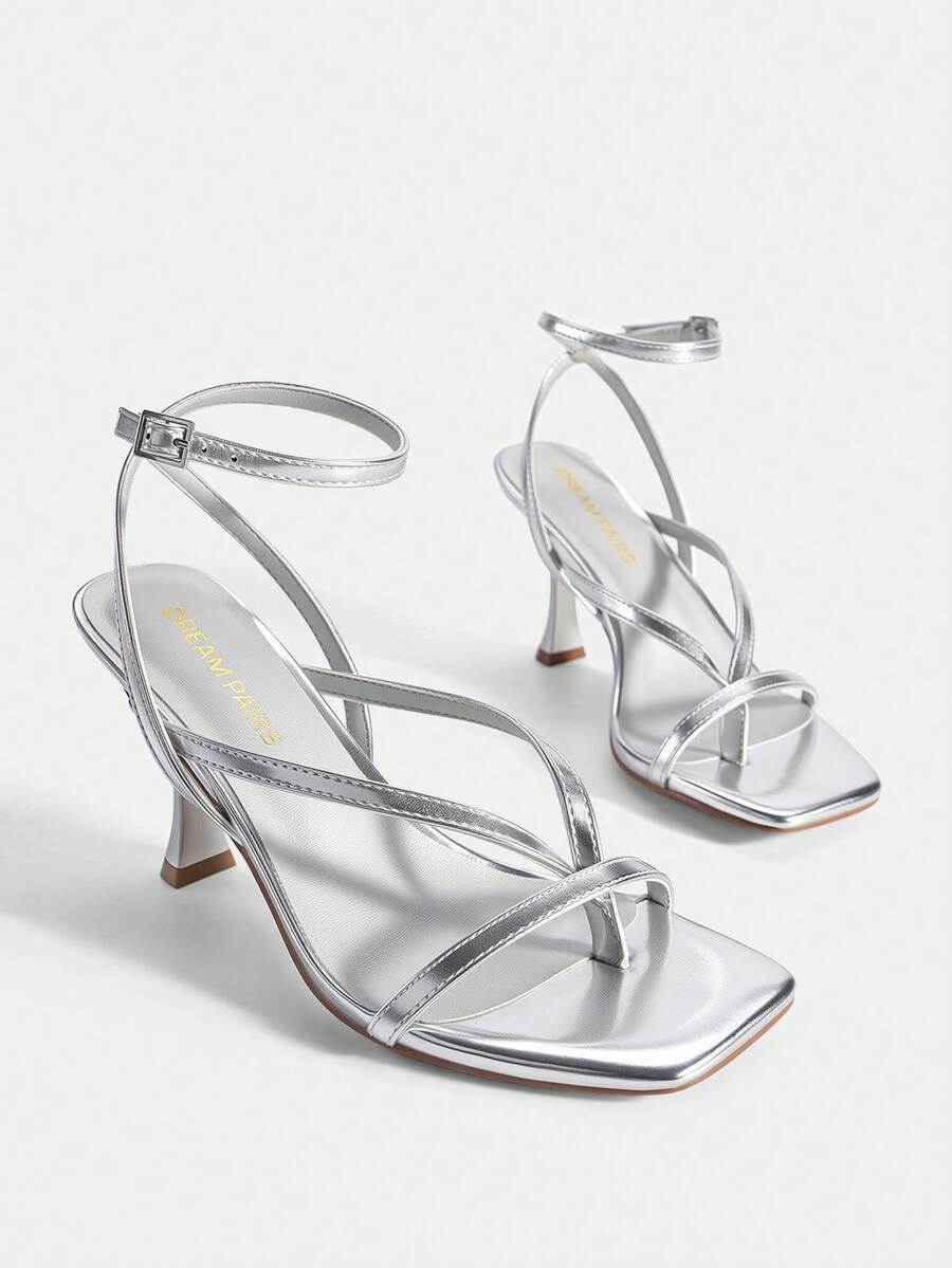 Open square toe kitten heel thong sandals with delicate cross-over straps and an adjustable ankle buckle strap.