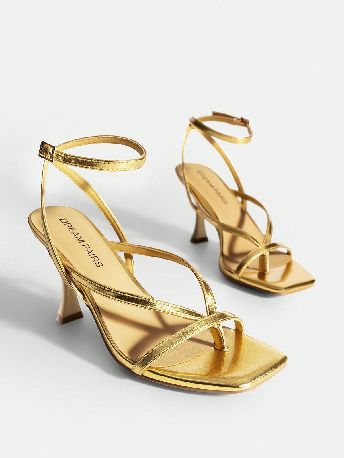 Women's metallic kitten low heel thong sandals featuring an open square toe and slip-on mule design.