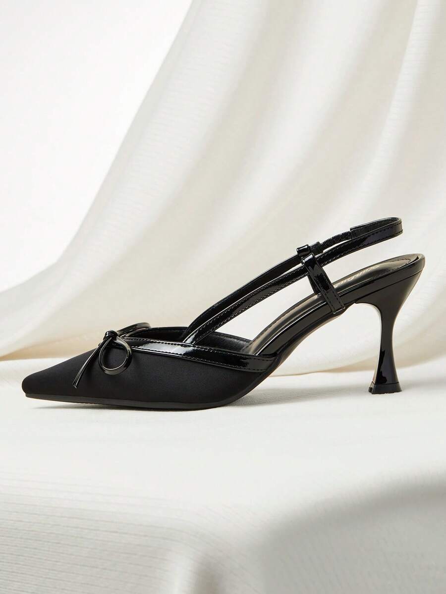 Women's black pointed toe slingback heels featuring a bowknot accent, closed toe design, adjustable buckle strap, and pyramid mid heel.