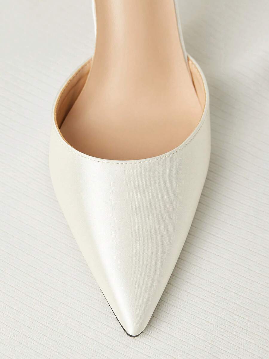 White satin bridal high heels with an elegant bow knot accent, pointed toe, and slingback stiletto heel for weddings and formal events.