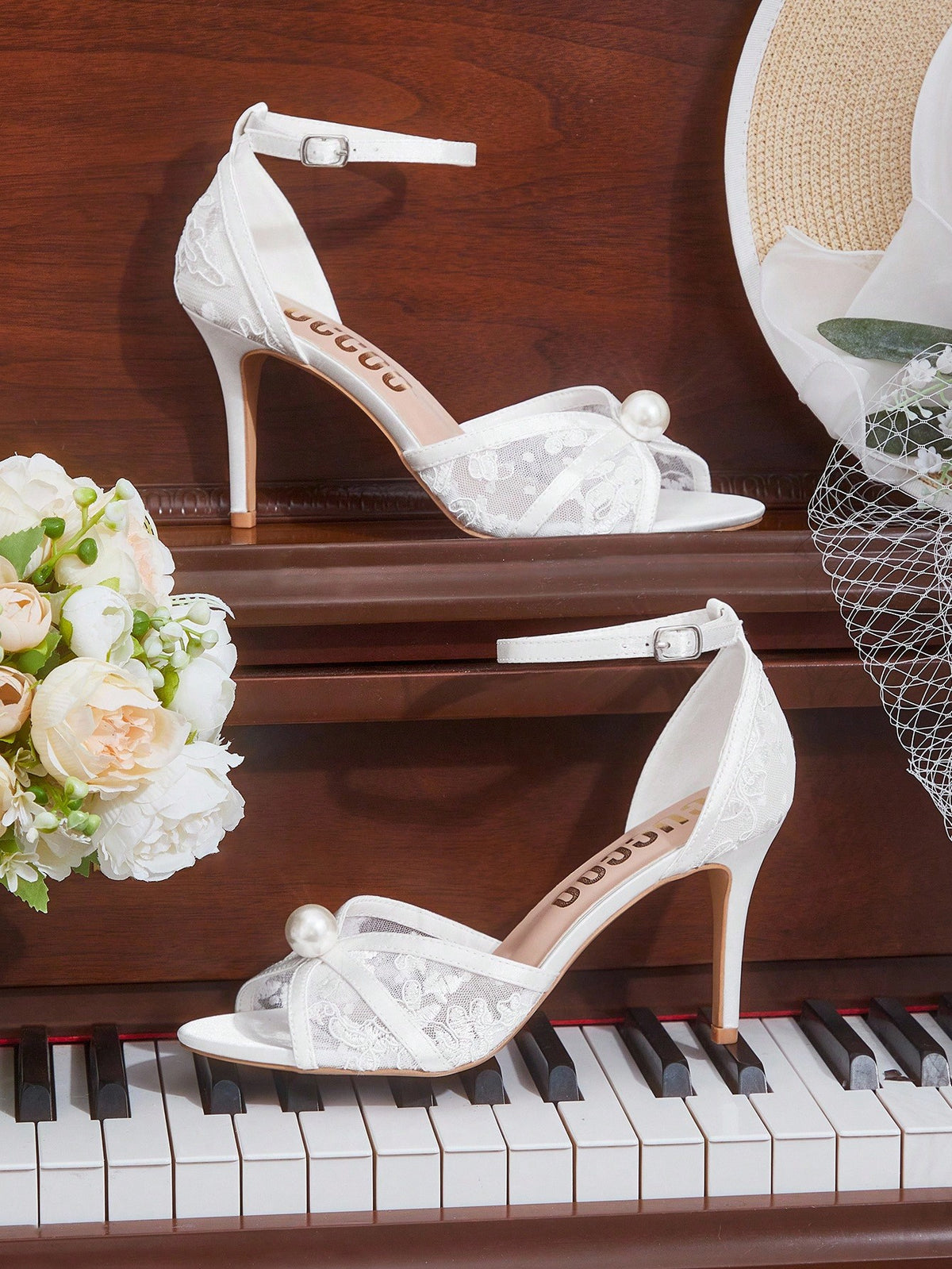 Beige high heel sandals with delicate lace overlay, pearl embellishments, stiletto heel, and adjustable ankle strap for bride and wedding party wear.