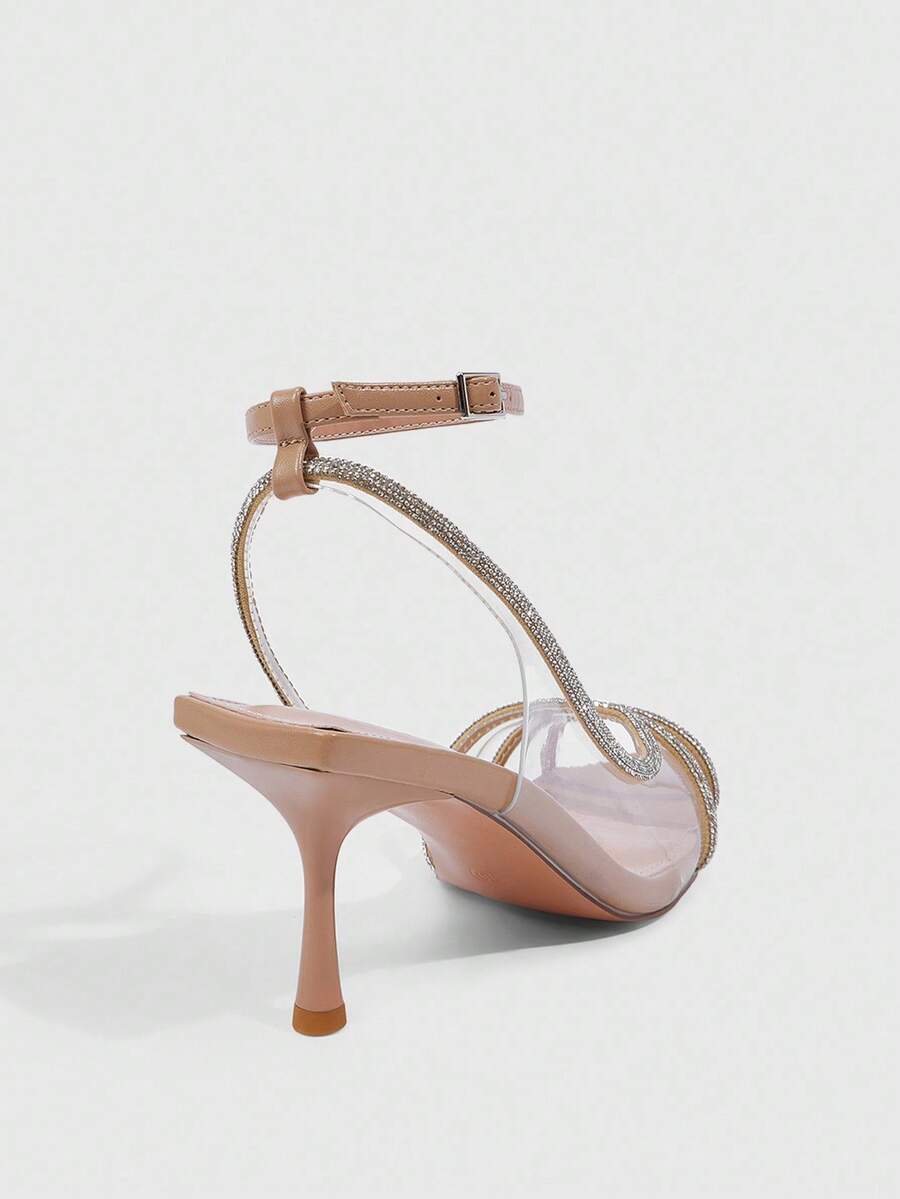 Women's gold open toe high heel sandals featuring sparkling rhinestone ankle strap and transparent upper
