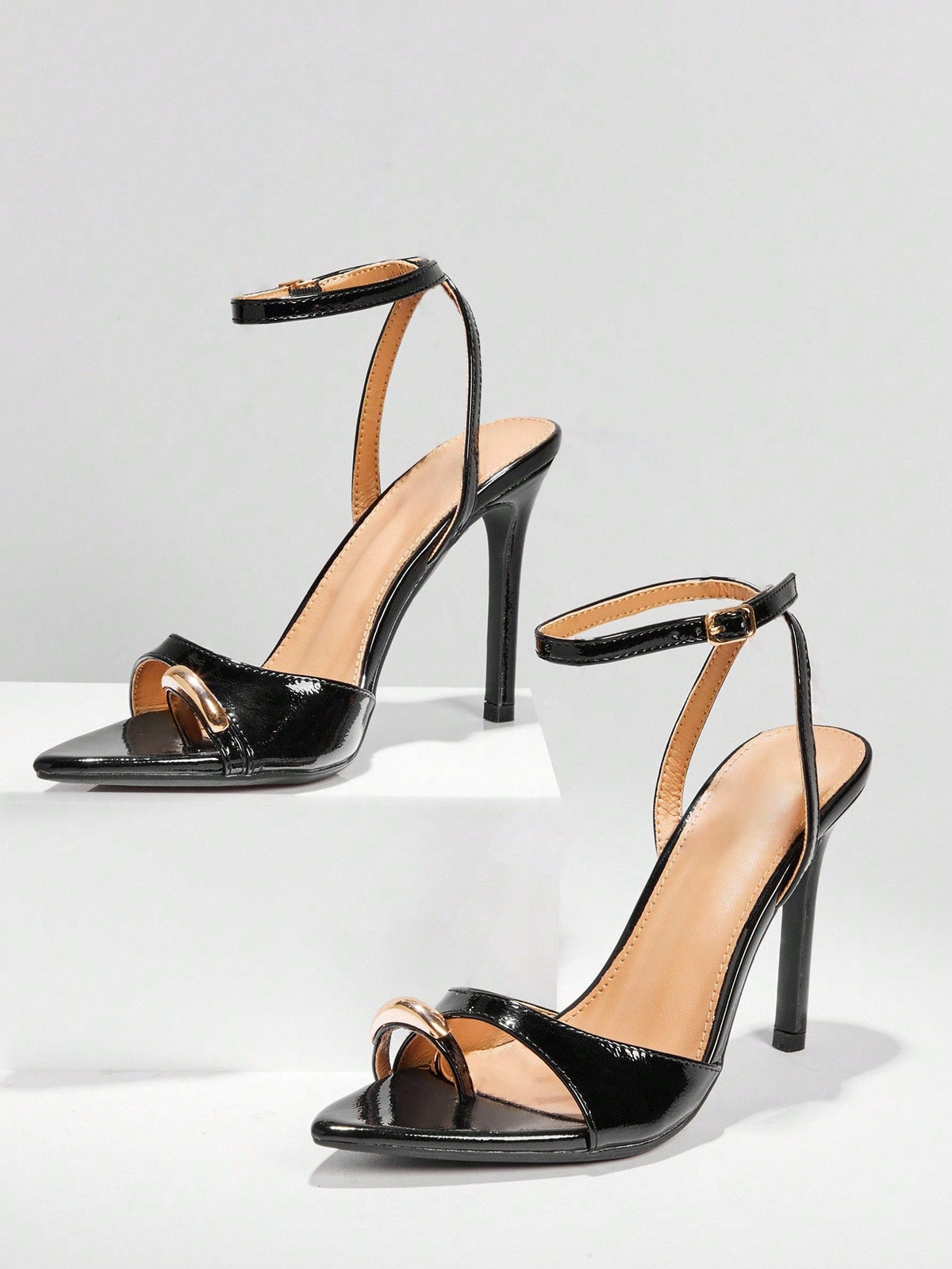 Women's pointed toe stiletto high heel wedding shoes featuring an elegant silhouette and glossy finish.
