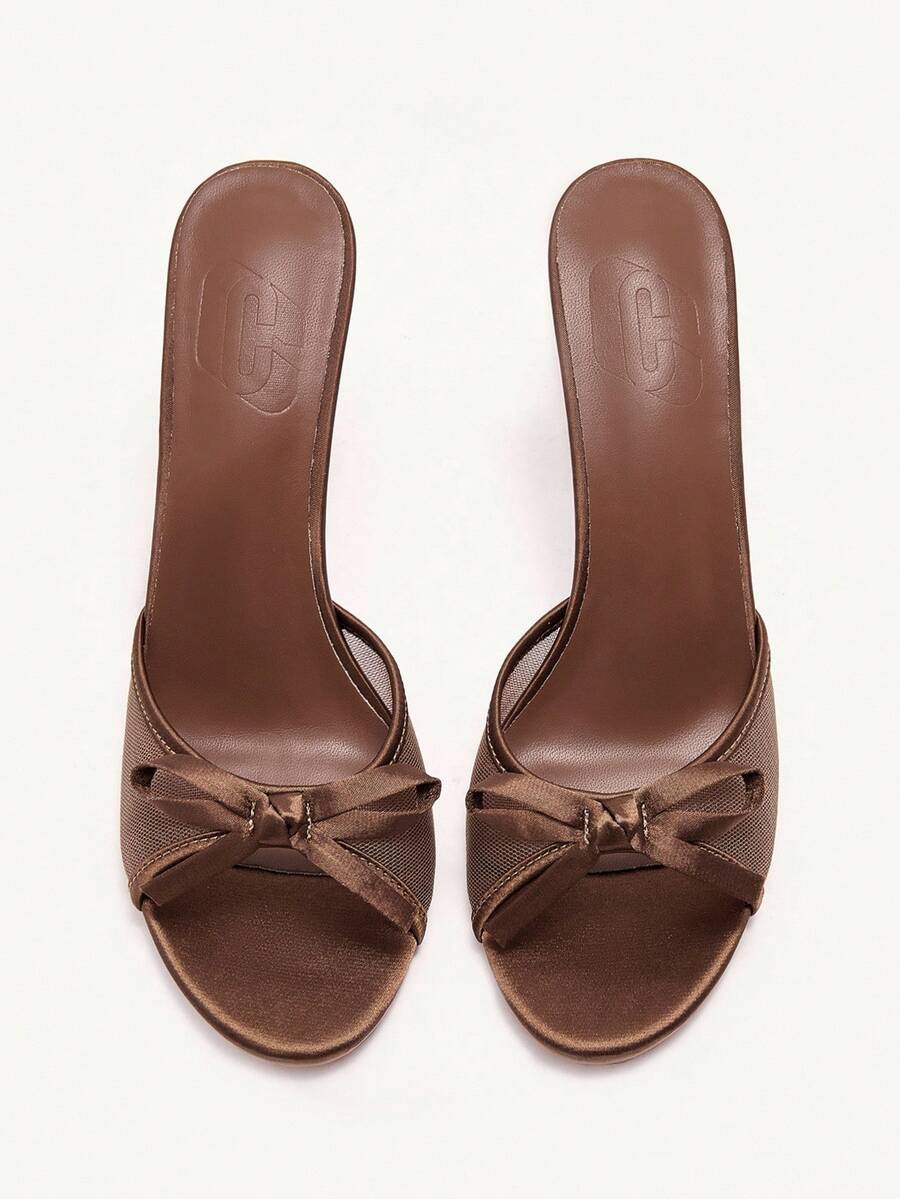 Elegant women's pointed toe high heel mules crafted from smooth PU leather with stiletto heels and delicate bow detail.