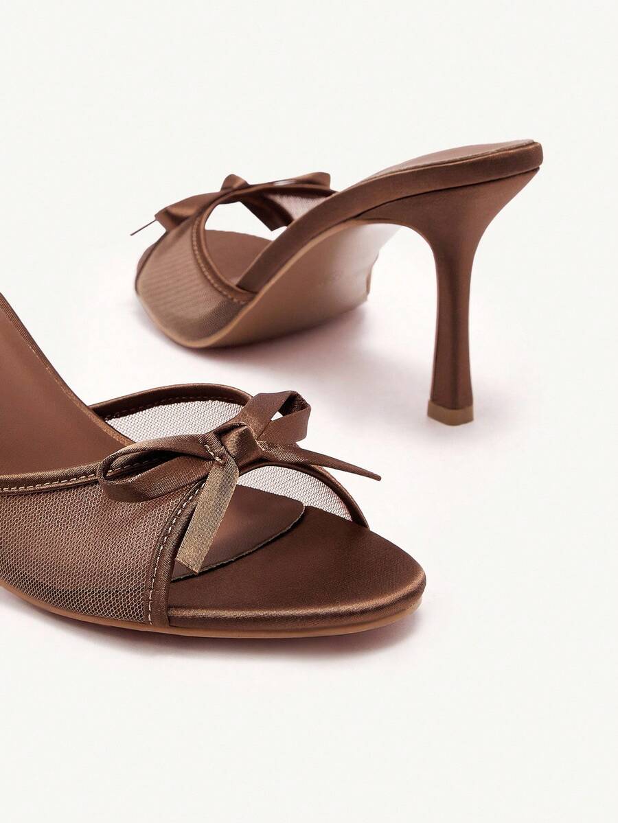 Elegant women's pointed toe high heel mules crafted from smooth PU leather with stiletto heels and delicate bow detail.