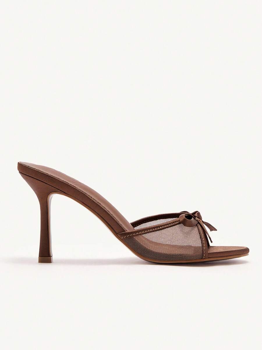 Elegant women's pointed toe high heel mules crafted from smooth PU leather with stiletto heels and delicate bow detail.