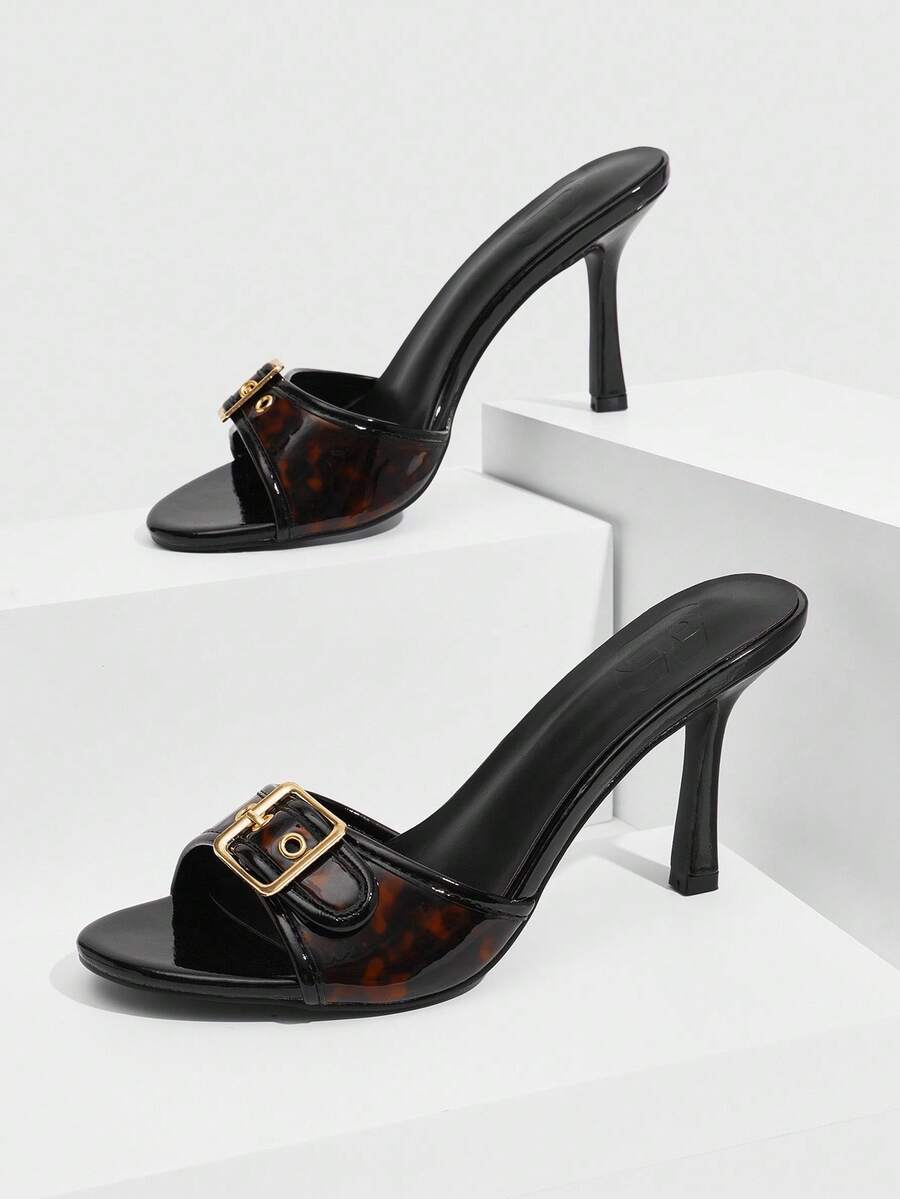 Women's brown leopard print high heel mule sandals with gold-tone buckle and grommet eyelet accents.