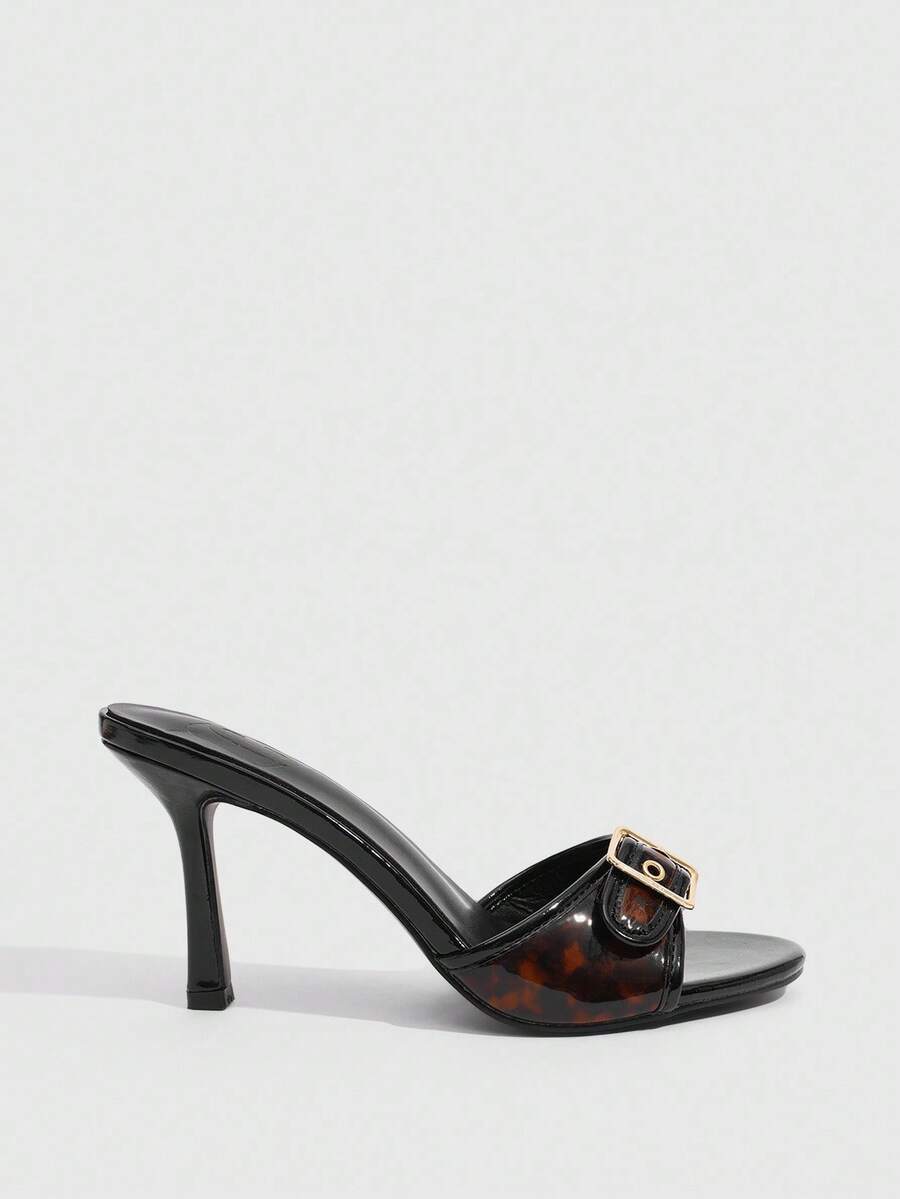 Women's brown leopard print high heel mule sandals with gold-tone buckle and grommet eyelet accents.