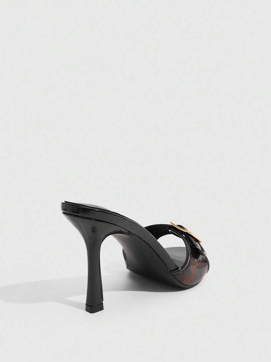 Women's brown leopard print high heel mule sandals with gold-tone buckle and grommet eyelet accents.