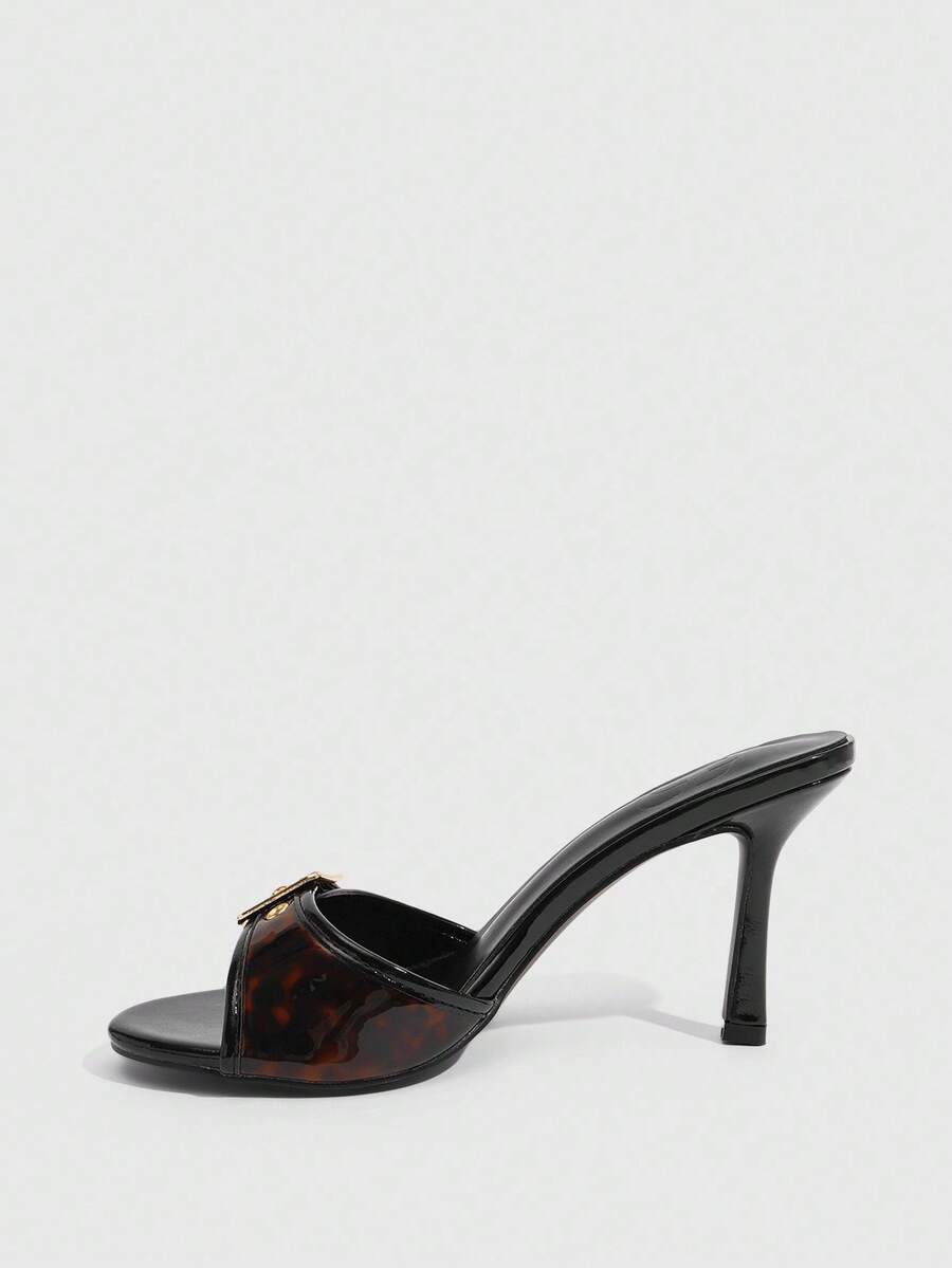 Women's brown leopard print high heel mule sandals with gold-tone buckle and grommet eyelet accents.