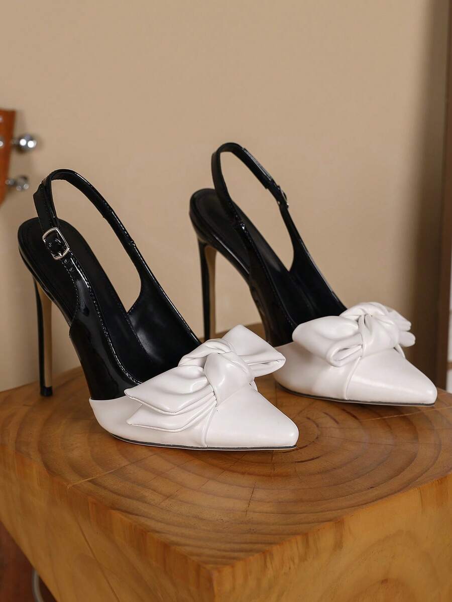 Women's pointed toe stiletto high heel pumps featuring a lace bow accent and slingback buckle strap.