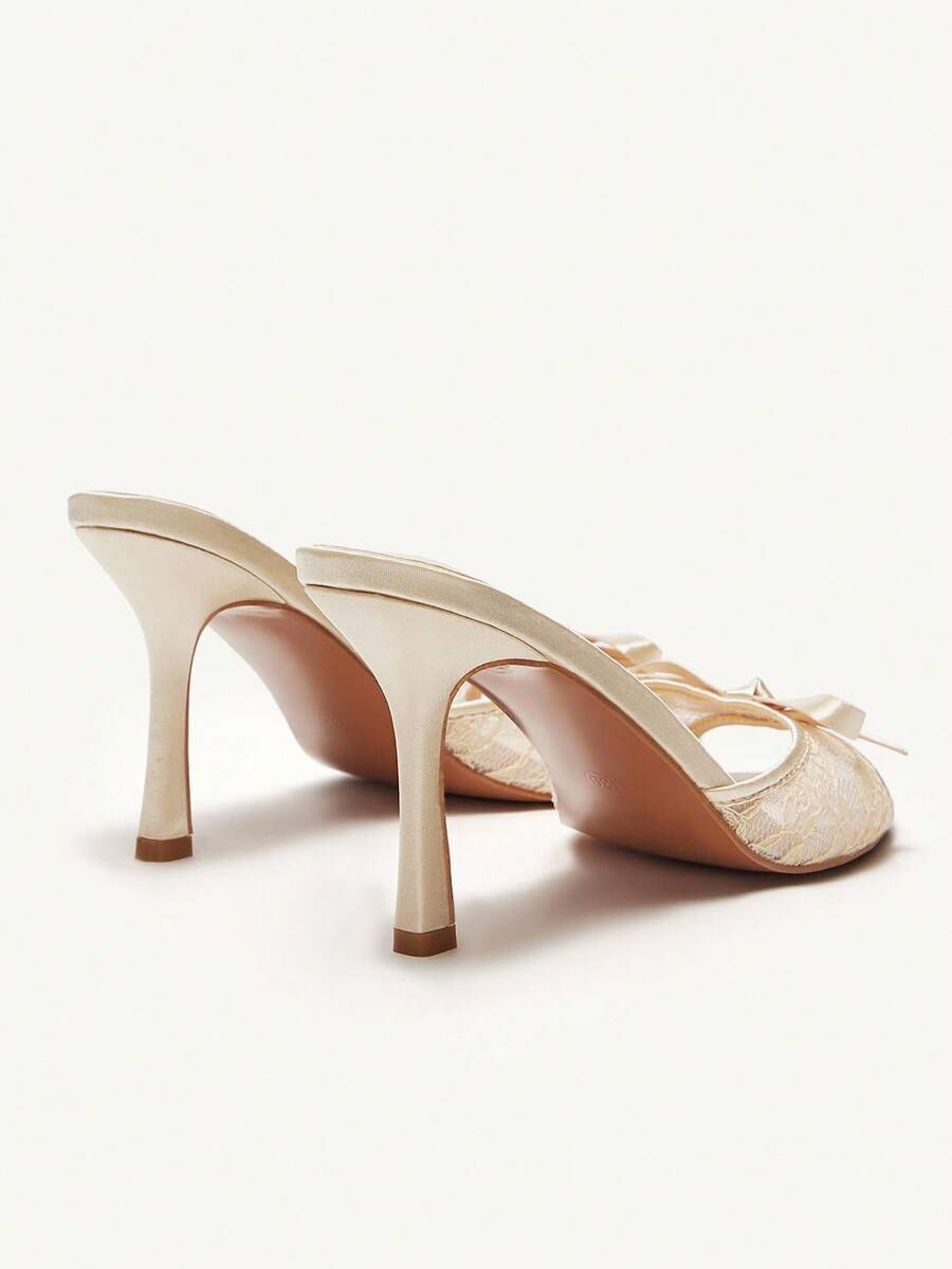 Elegant women's pointed toe high heel mules crafted from smooth PU leather with stiletto heels and delicate bow detail.