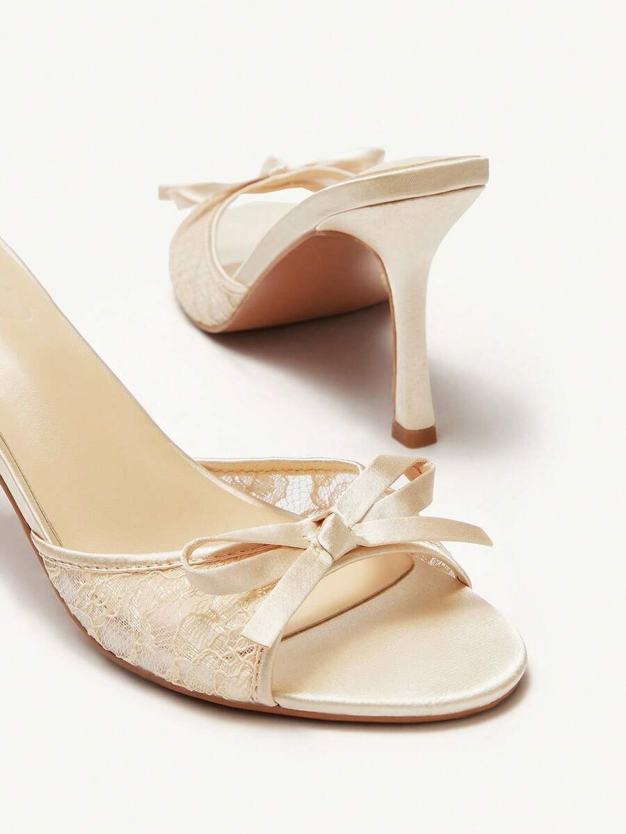 Elegant women's pointed toe high heel mules crafted from smooth PU leather with stiletto heels and delicate bow detail.