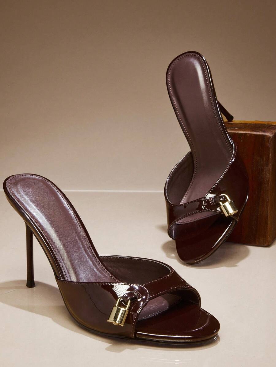 Women's slip-on heeled sandals with metal-coated stiletto heels and lock decoration in chocolate brown PU leather.