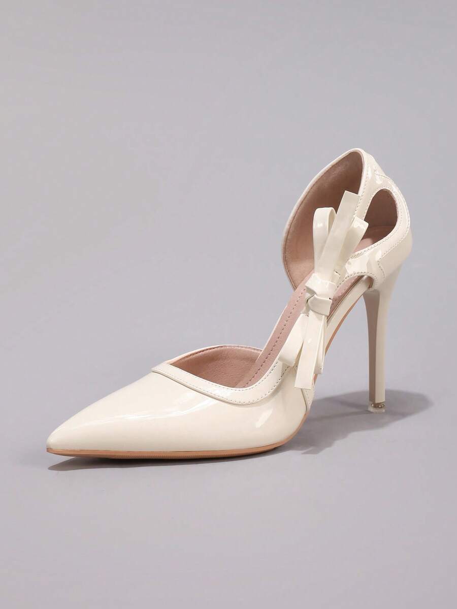 Lace embroidered high heels with thin stiletto heel, pointed toe, rhinestone embellishments, and ankle strap buckle closure.