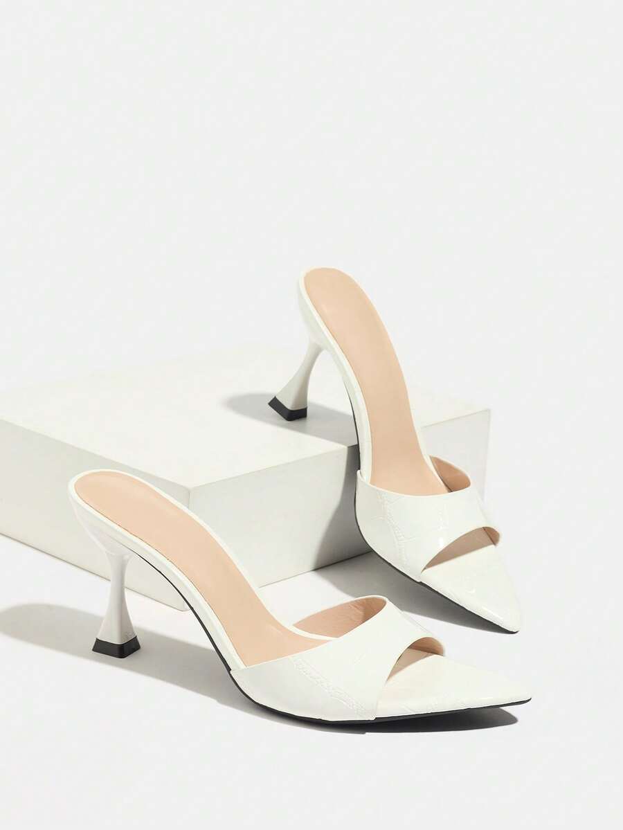 Women's pointed toe high heel mule sandals featuring a sleek slip-on design with elegant lace embroidery detailing