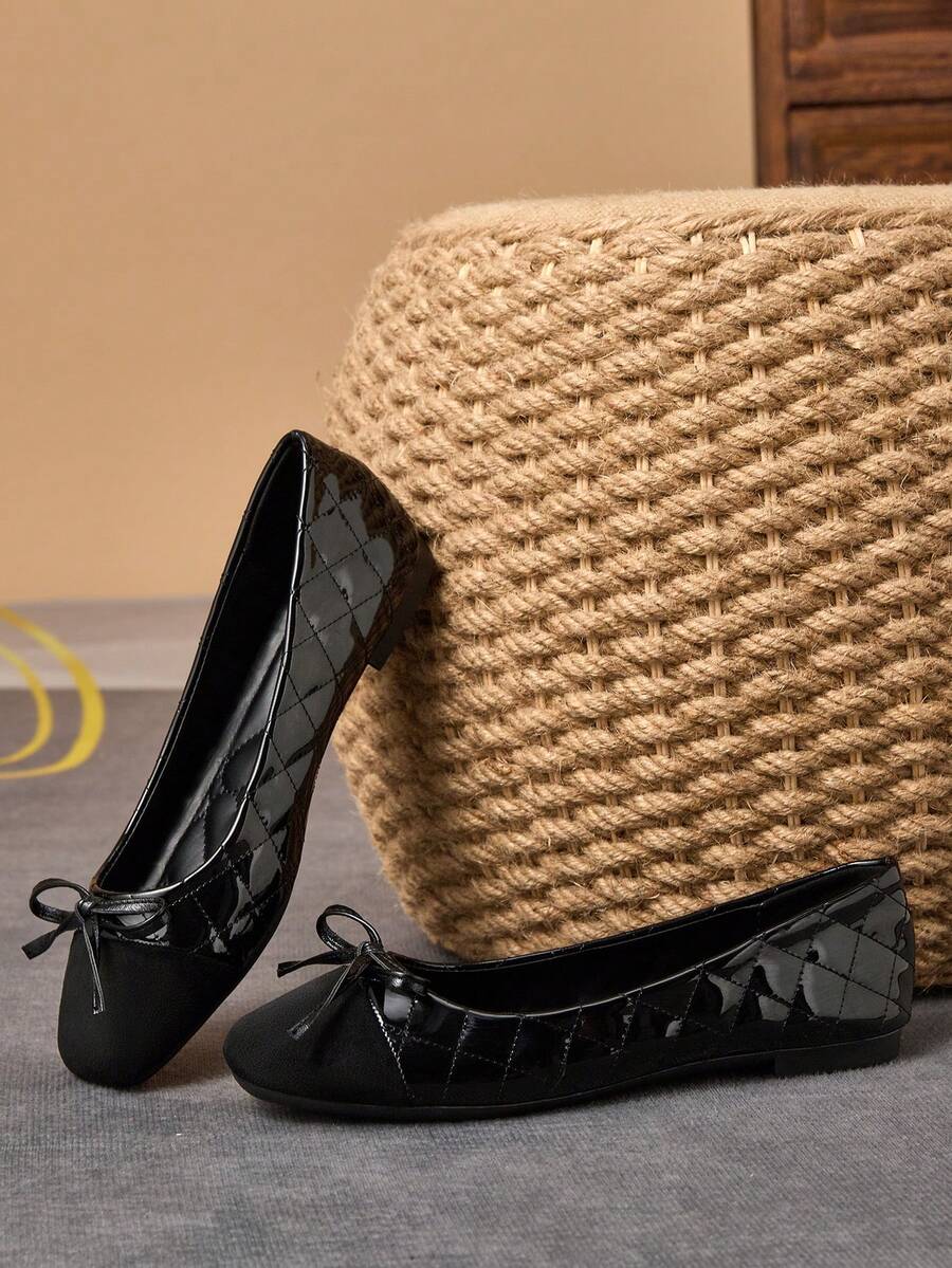 Pair of women's square toe slip-on flat shoes featuring a delicate bow detail and low vamp design.