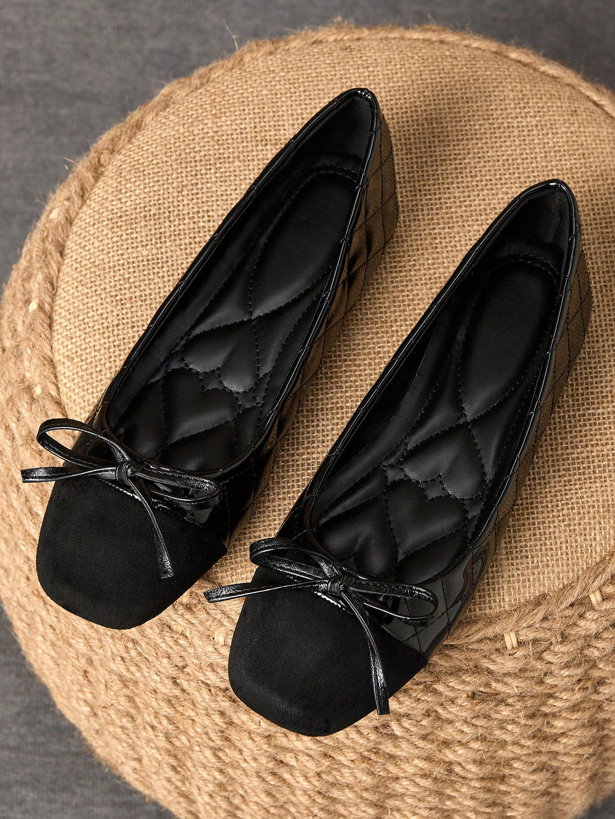 Pair of women's square toe slip-on flat shoes featuring a delicate bow detail and low vamp design.