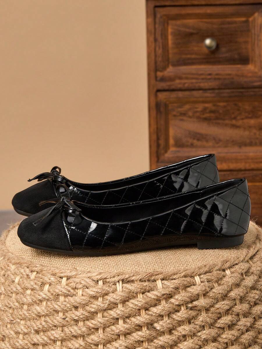 Pair of women's square toe slip-on flat shoes featuring a delicate bow detail and low vamp design.
