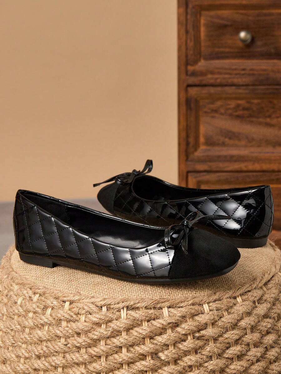 Pair of women's square toe slip-on flat shoes featuring a delicate bow detail and low vamp design.