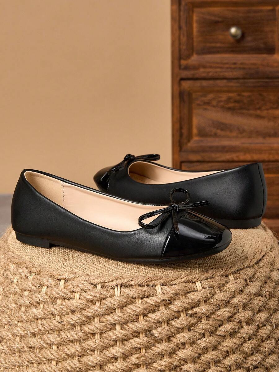 Pair of women's square toe slip-on flat shoes featuring a delicate bow detail and low vamp design.