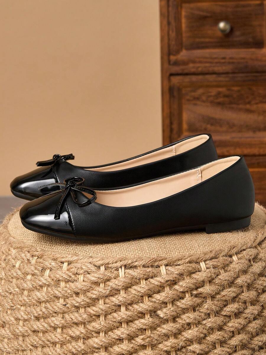 Pair of women's square toe slip-on flat shoes featuring a delicate bow detail and low vamp design.