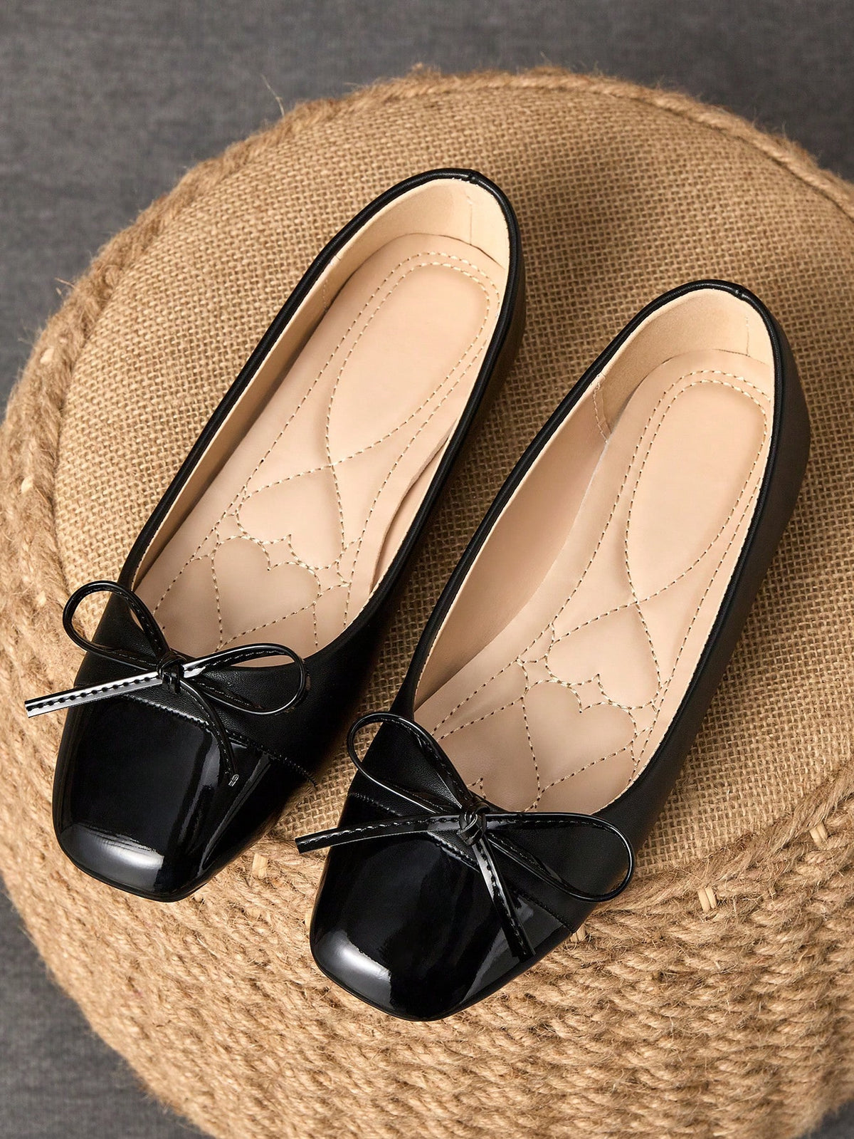 Pair of women's square toe slip-on flat shoes featuring a delicate bow detail and low vamp design.