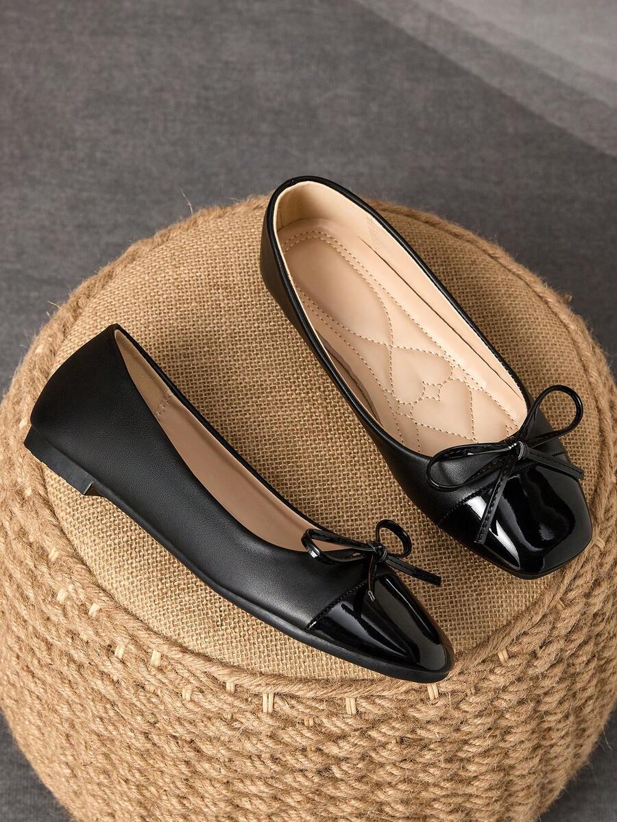 Pair of women's square toe slip-on flat shoes featuring a delicate bow detail and low vamp design.