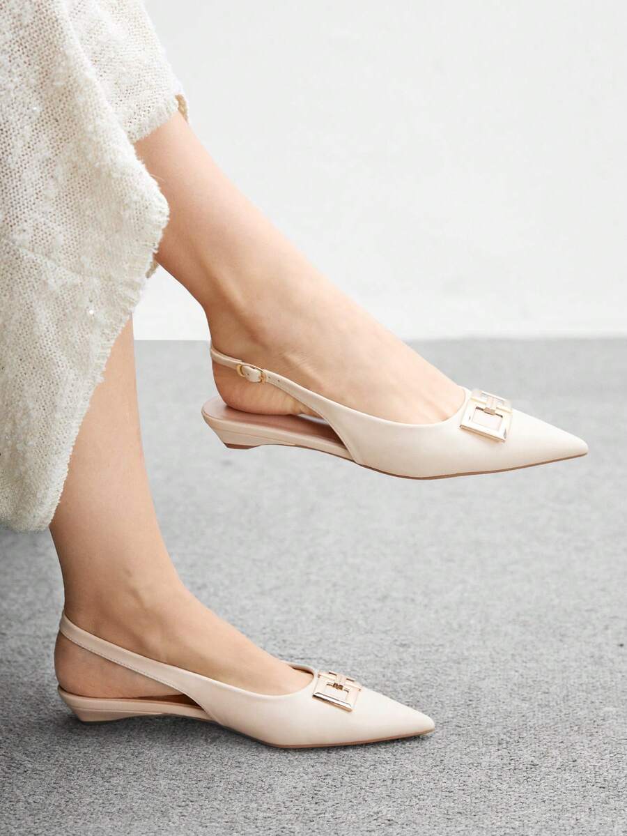 Women's pointed toe low wedge flat shoes crafted in PU leather with a slingback strap and stylish metal buckle detail.