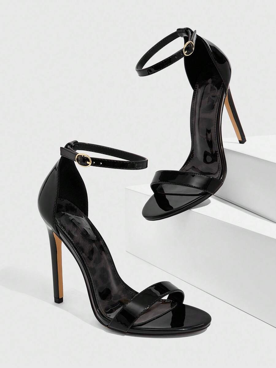 Women's stiletto sandals featuring an ankle strap buckle closure and classic round open toe design.