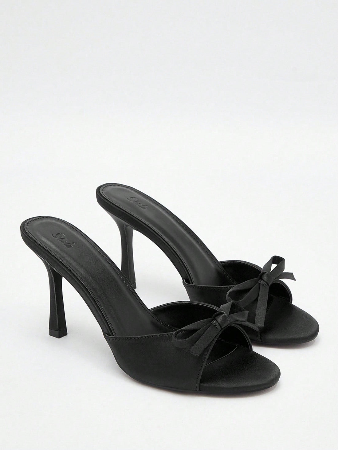 Pair of women's open toe stiletto heeled sandals crafted in satin with a bow accent