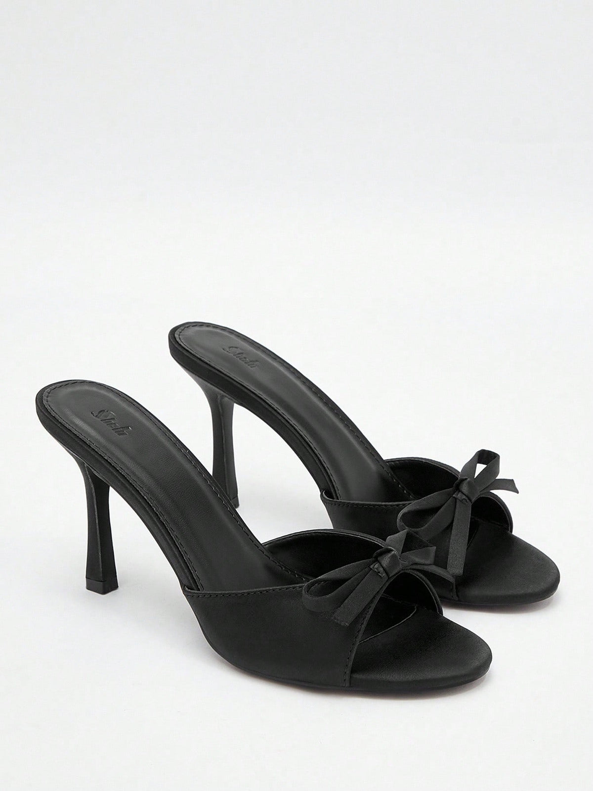 Pair of women's open toe stiletto heeled sandals crafted in satin with a bow accent