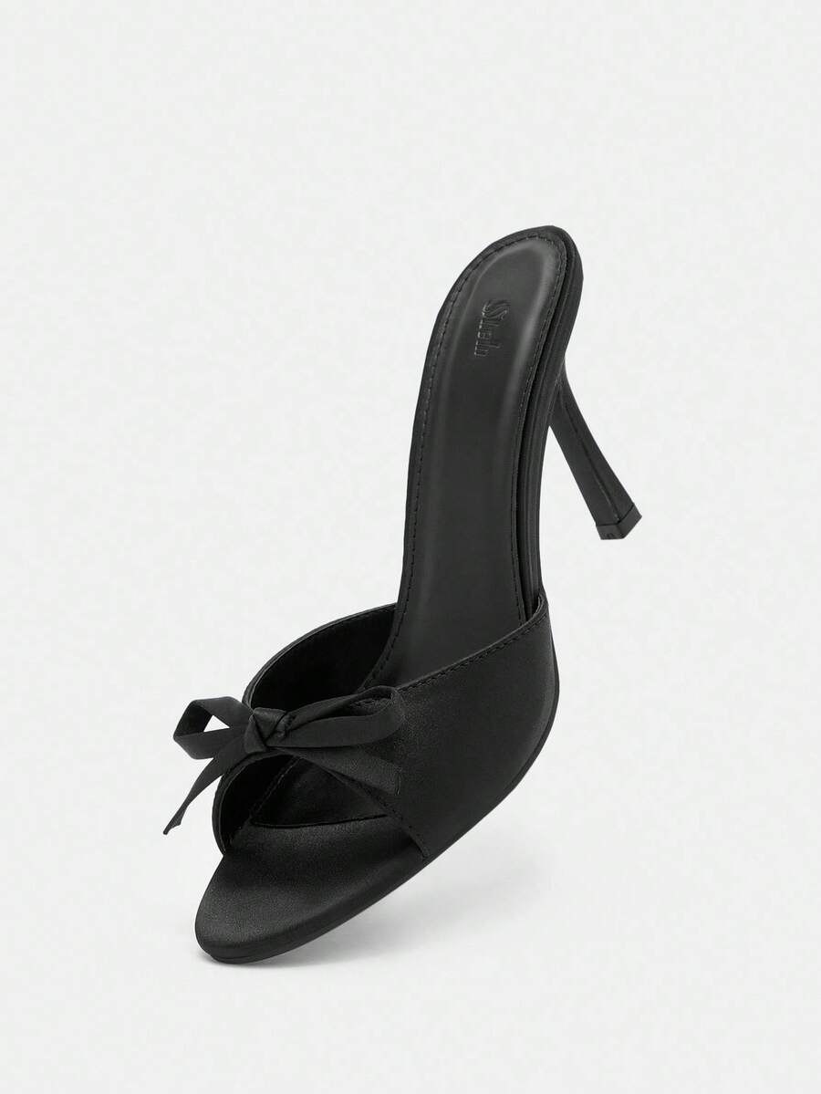Pair of women's open toe stiletto heeled sandals crafted in satin with a bow accent