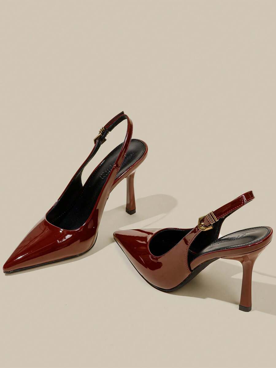 Women's pointed toe kitten heel pumps with adjustable buckle back strap and sleek patent finish.