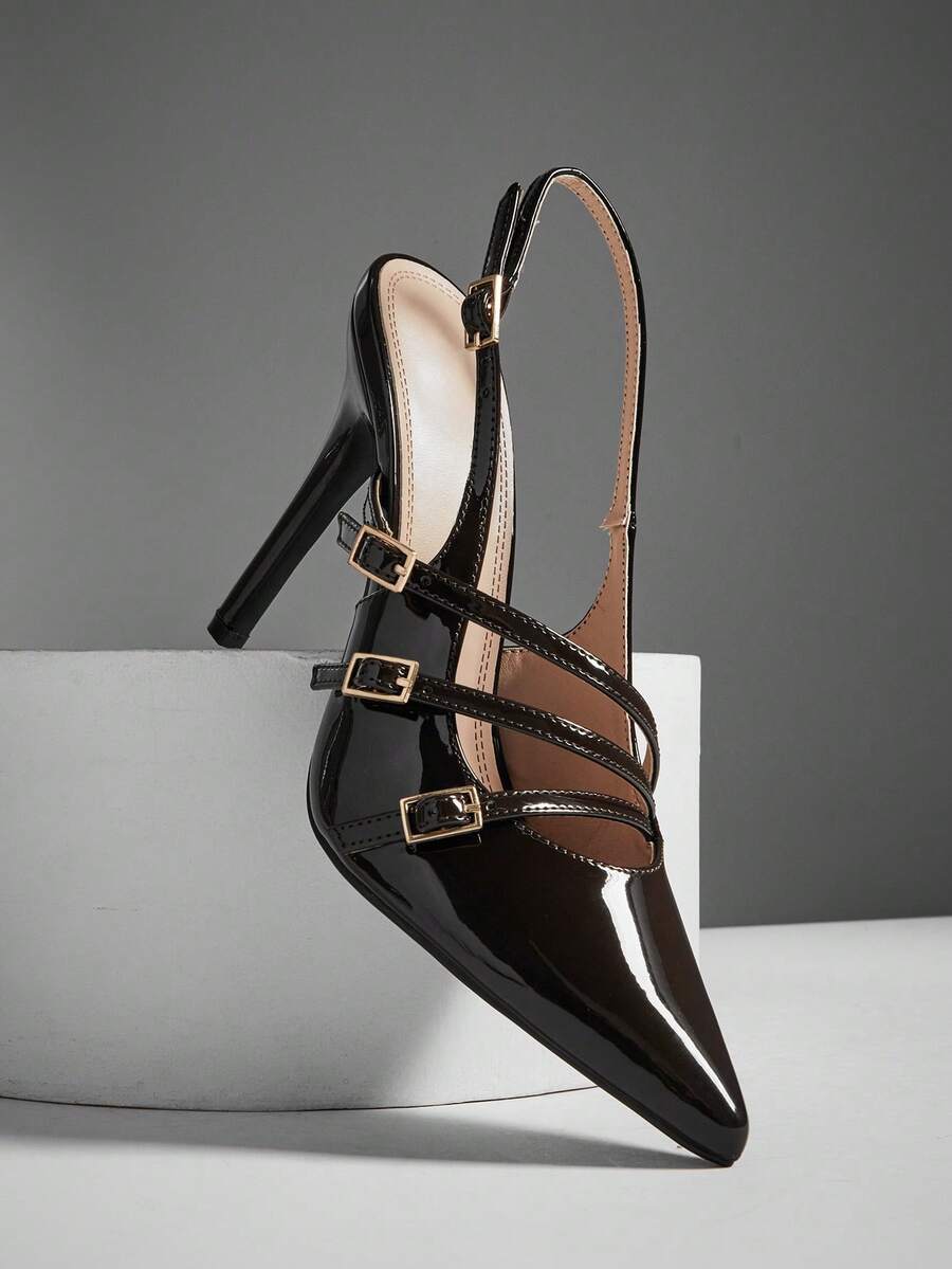 Women's pointed toe stiletto heel slingback pumps in chocolate brown with double metal buckle strap details.