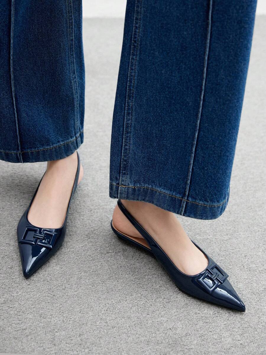 Women's pointed toe low wedge flat shoes crafted in PU leather with a slingback strap and stylish metal buckle detail.