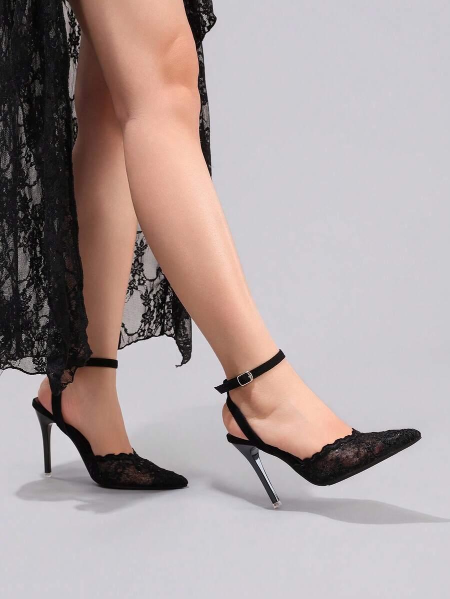 Lace embroidered high heels with thin stiletto heel, pointed toe, rhinestone embellishments, and ankle strap buckle closure.