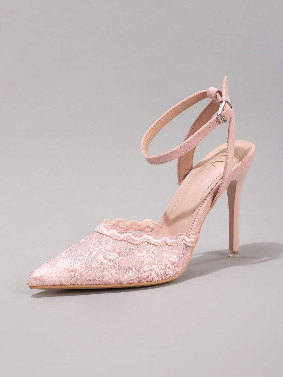 Lace embroidered high heels with thin stiletto heel, pointed toe, rhinestone embellishments, and ankle strap buckle closure.