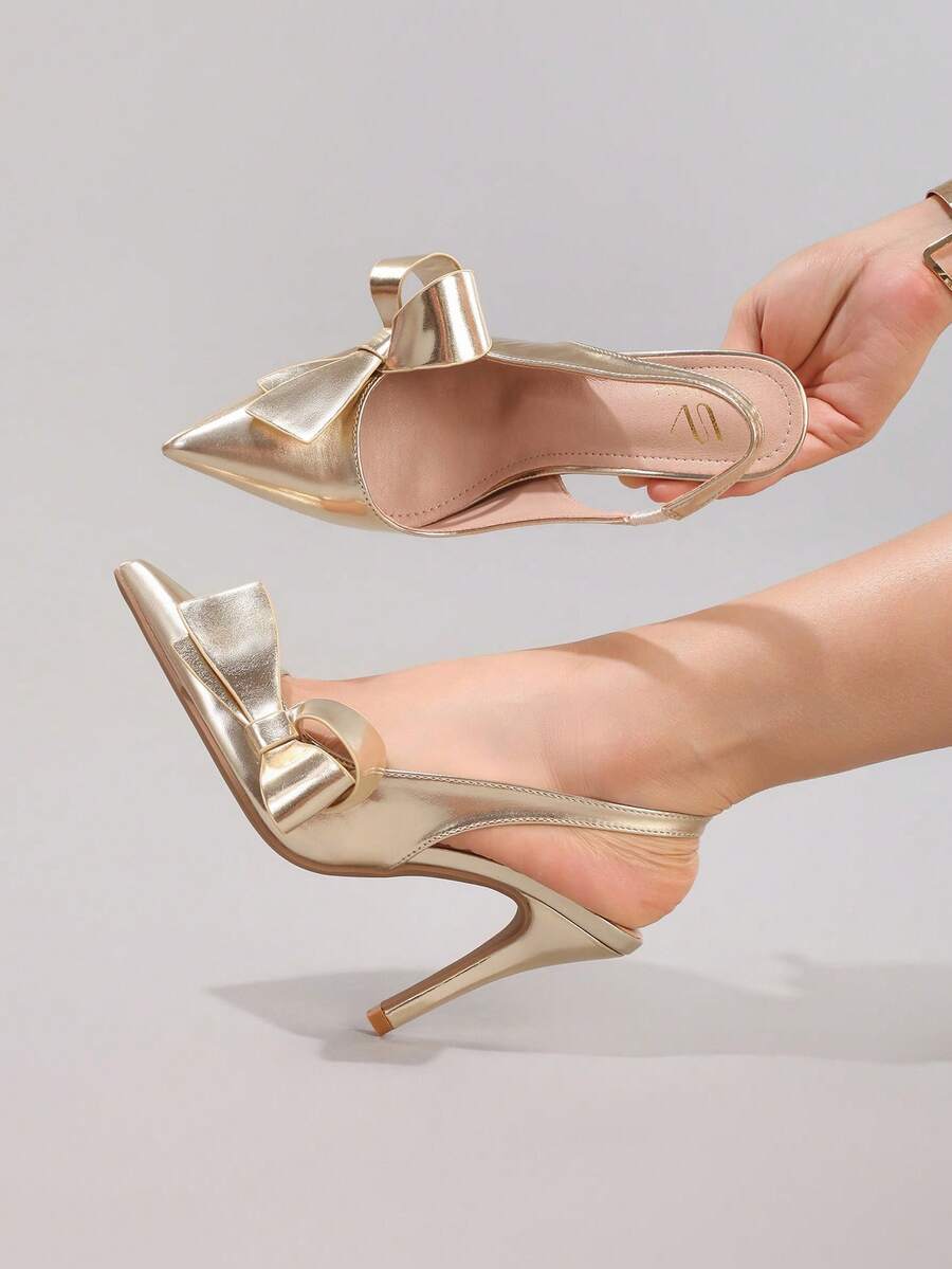Black lace pointed toe high heel pumps featuring stiletto heels and a decorative bow accent.