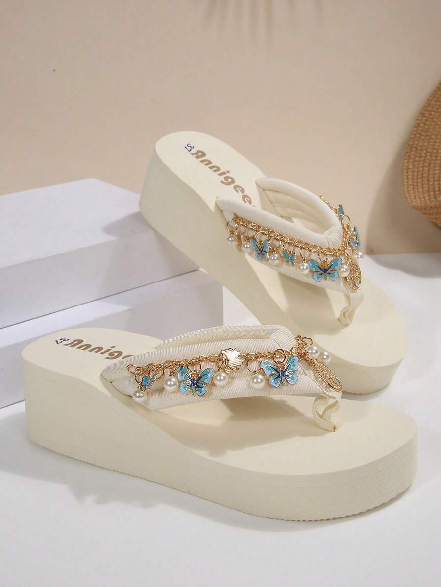 Beige platform wedge flip flop slippers featuring decorative chain and shell details with EVA sole for women.