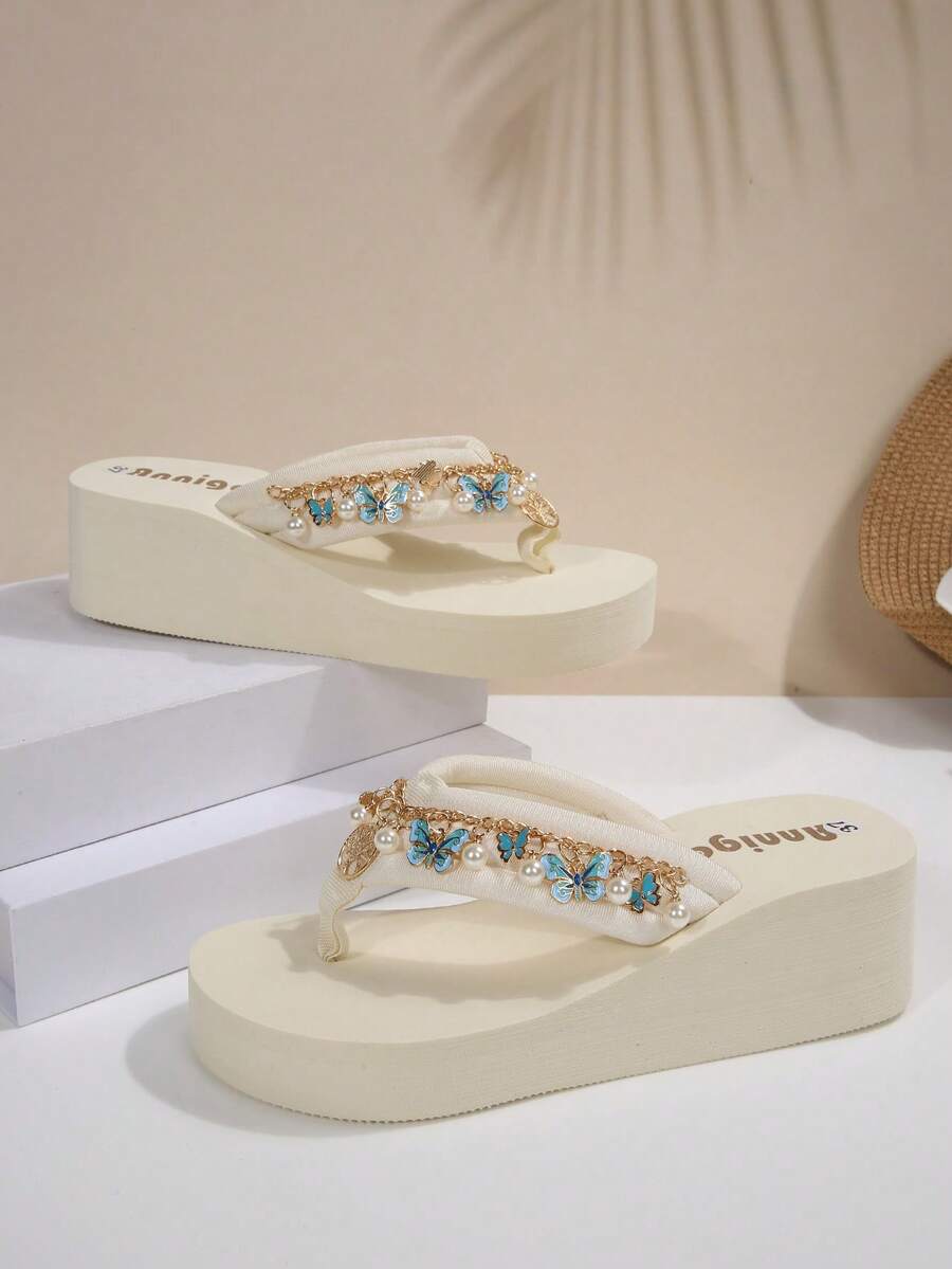 Beige platform wedge flip flop slippers featuring decorative chain and shell details with EVA sole for women.