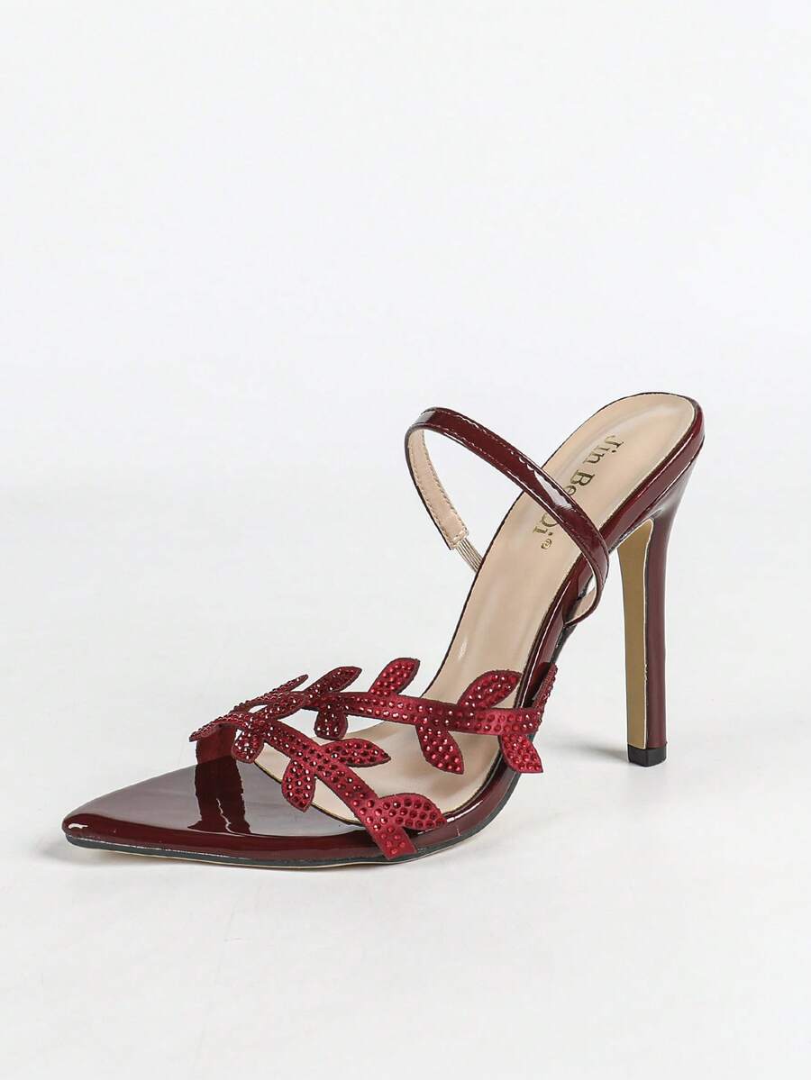 Women's stiletto high heel sandals with sparkling vine-shaped rhinestone ankle strap embellishments and open pointed toe design.