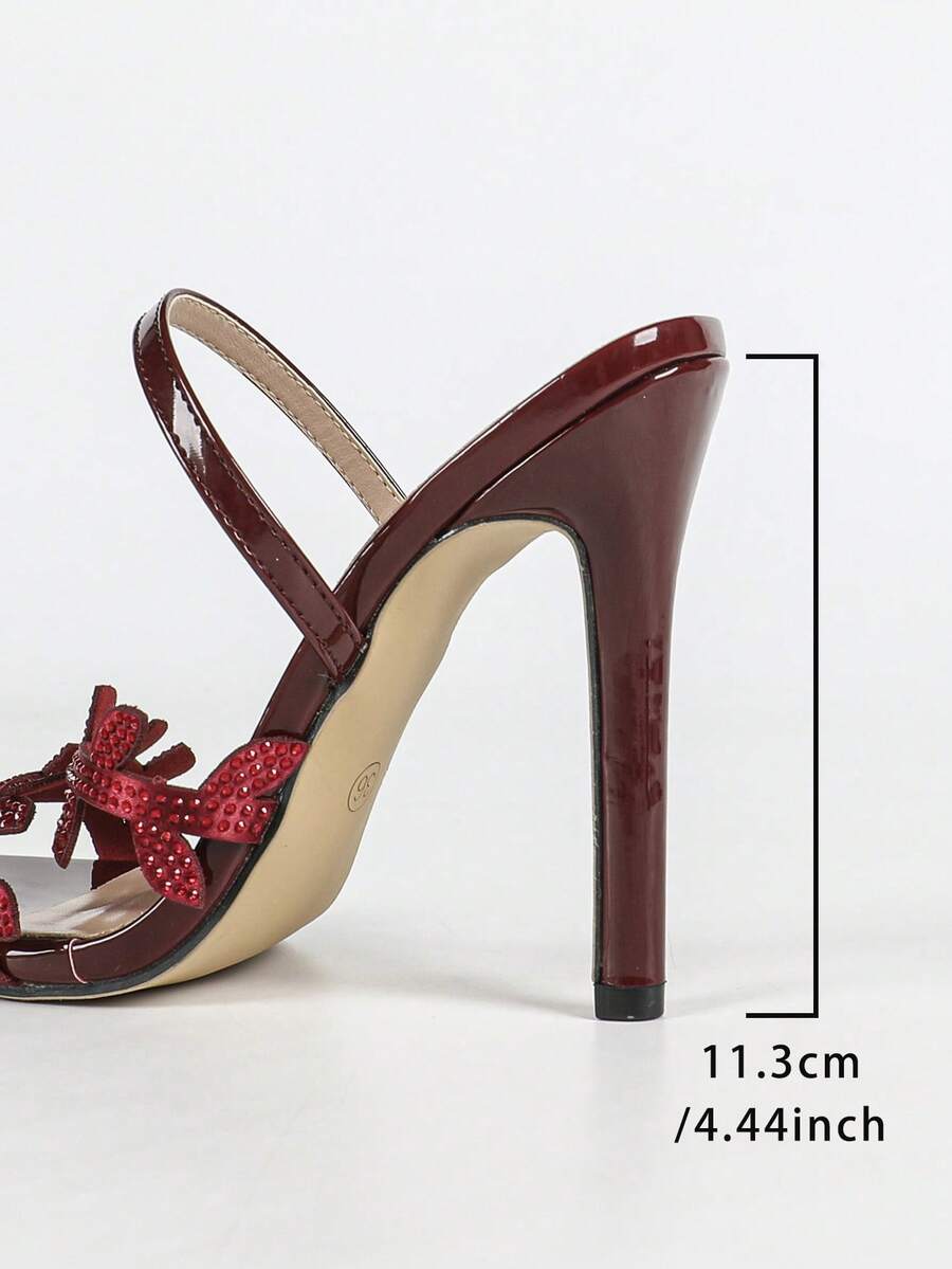 Women's stiletto high heel sandals with sparkling vine-shaped rhinestone ankle strap embellishments and open pointed toe design.