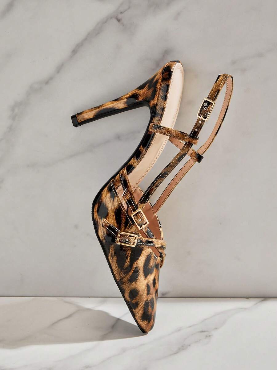 Women's pointed toe stiletto heel slingback pumps in chocolate brown with double metal buckle strap details.