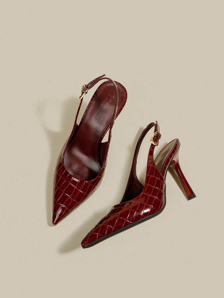 Women's pointed toe kitten heel pumps with adjustable buckle back strap and sleek patent finish.