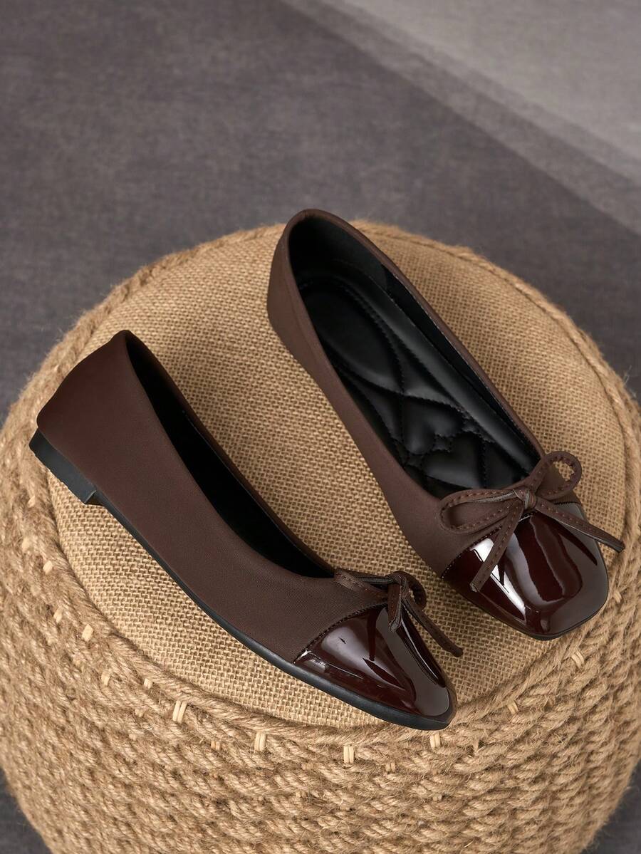 Pair of women's square toe slip-on flat shoes featuring a delicate bow detail and low vamp design.