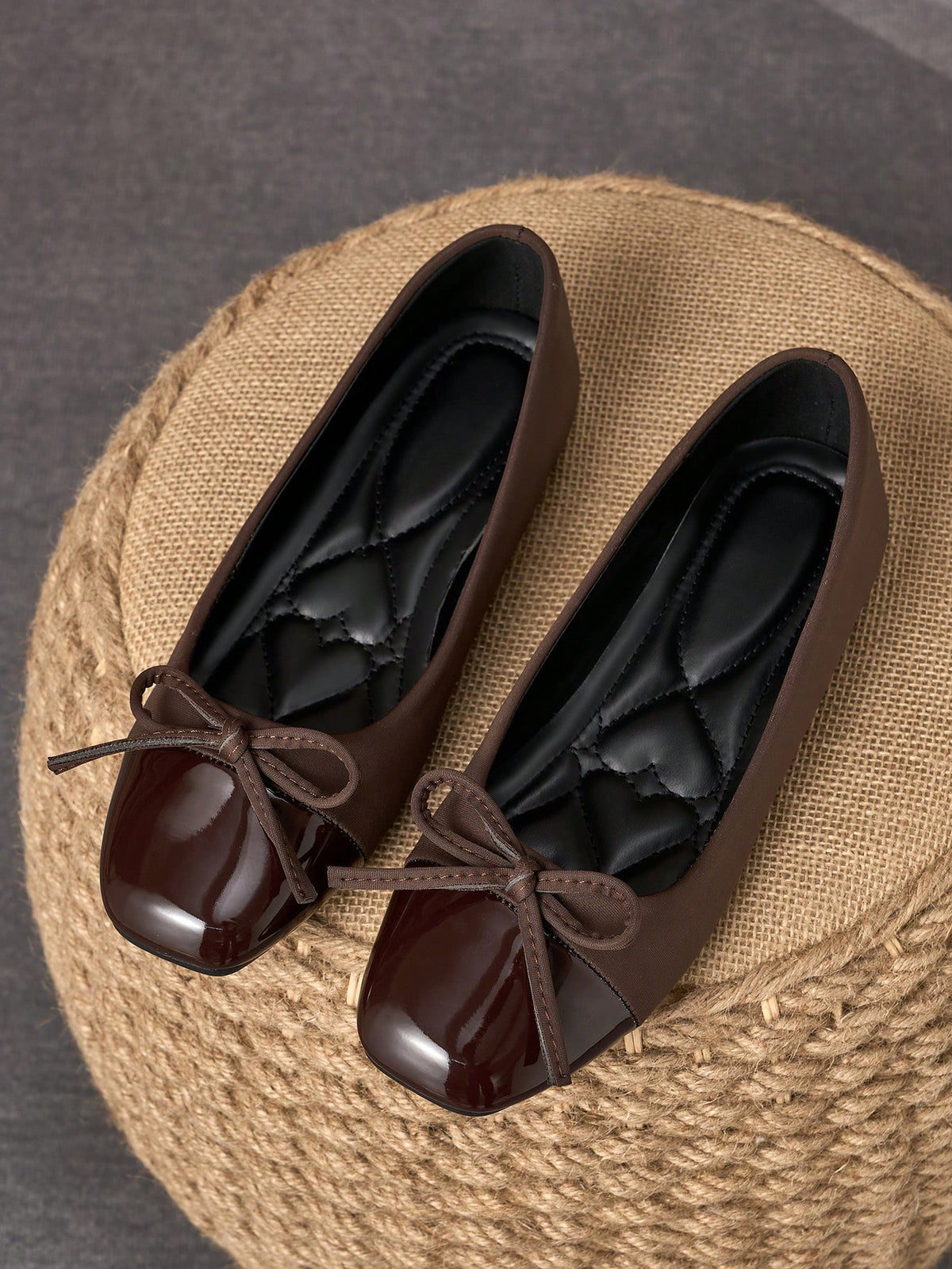 Pair of women's square toe slip-on flat shoes featuring a delicate bow detail and low vamp design.