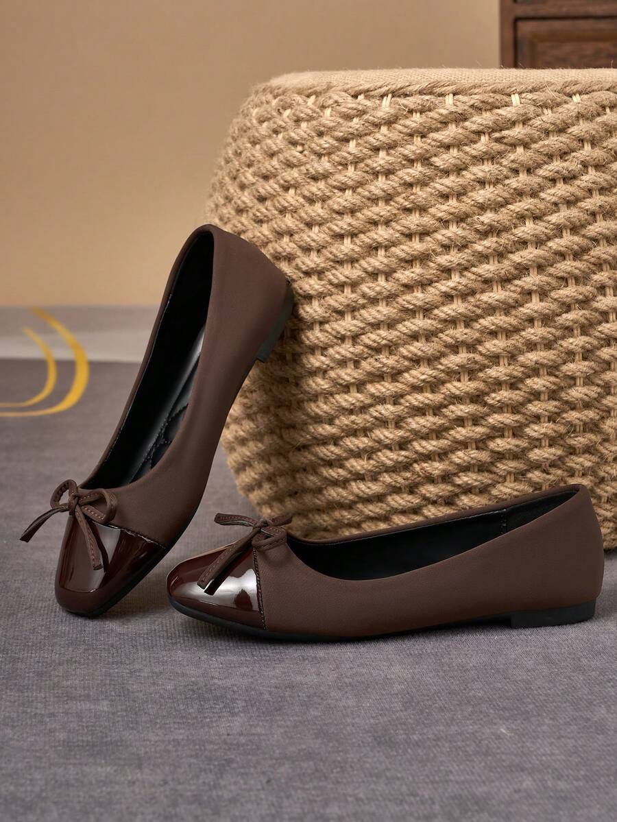 Pair of women's square toe slip-on flat shoes featuring a delicate bow detail and low vamp design.