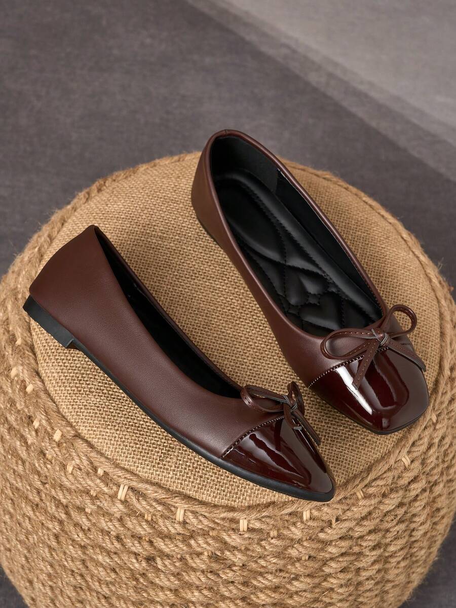 Pair of women's square toe slip-on flat shoes featuring a delicate bow detail and low vamp design.