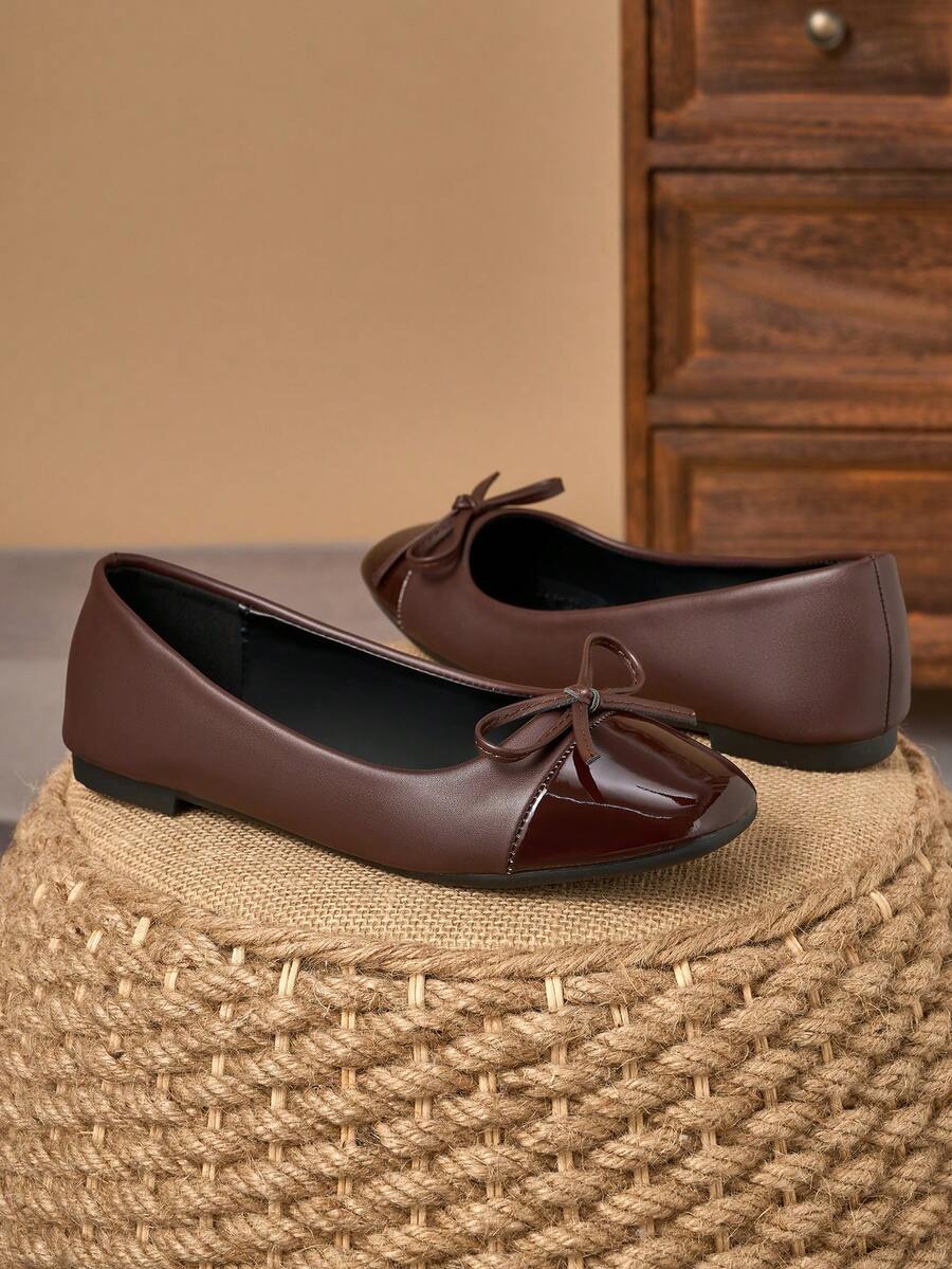 Pair of women's square toe slip-on flat shoes featuring a delicate bow detail and low vamp design.